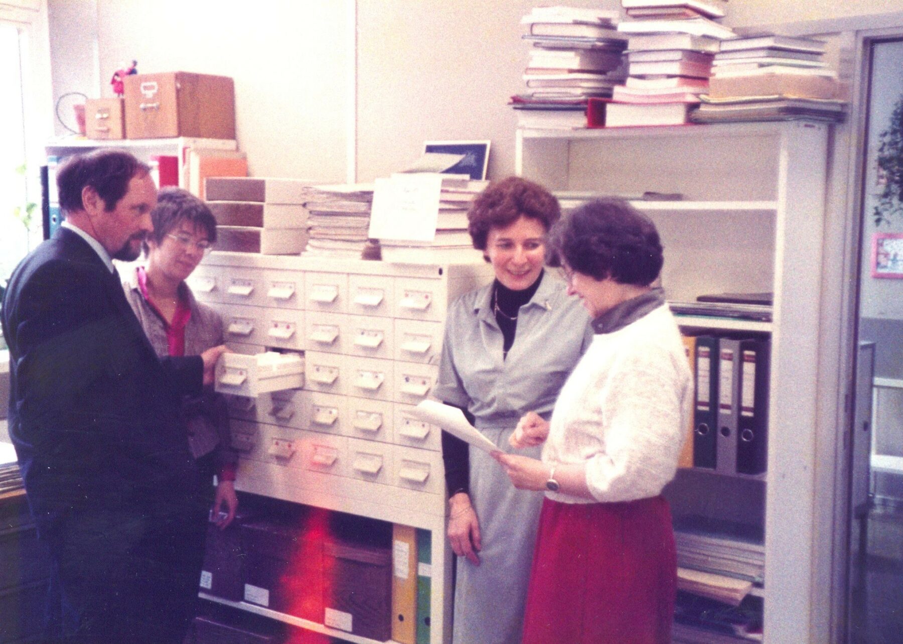 A man and three women in an office in the 70s